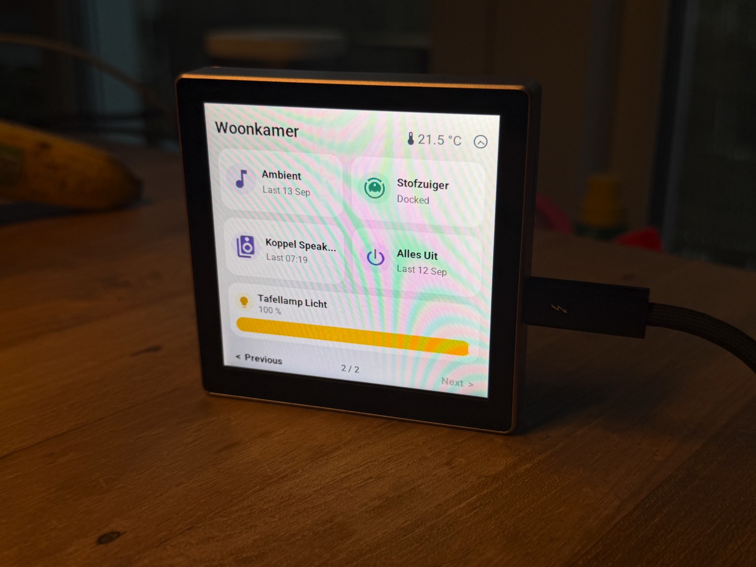 The Guition 4-inch screen on a table: the second page with scenes and scripts, the robot vacuum and a table lamp with a brightness slider